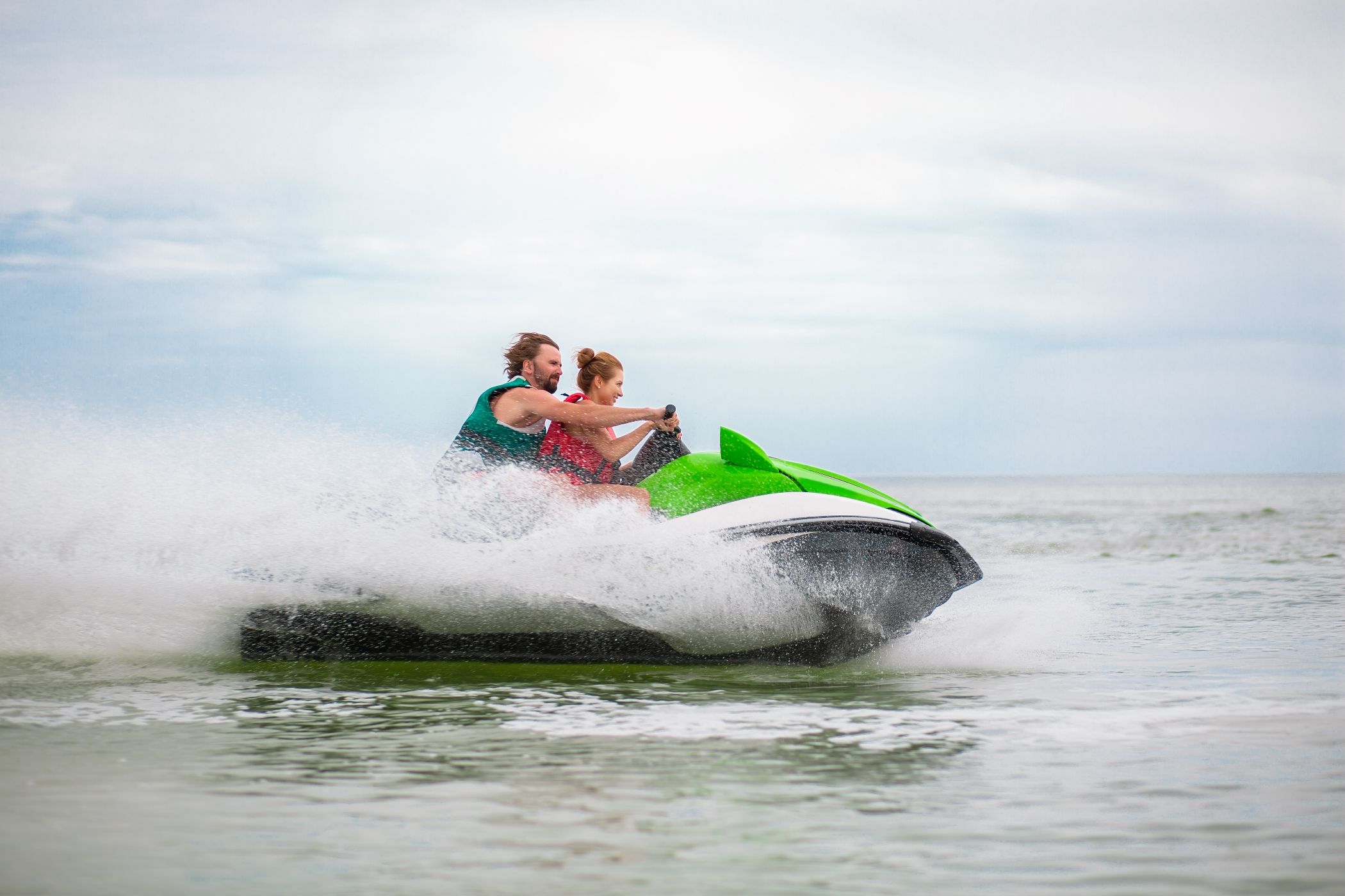 couple having fun on water scooter summer sea activity in Miami.